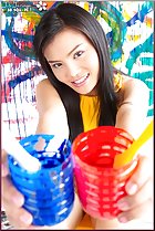  thai girls holding paint pots smiling broadly
