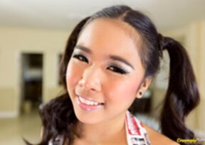 Kandi in pigtails strips knotted top and shorts wearing red fishnet stockings