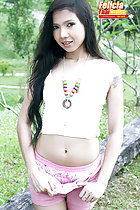 Standing with thumbs in her shorts long hair over her shoulder