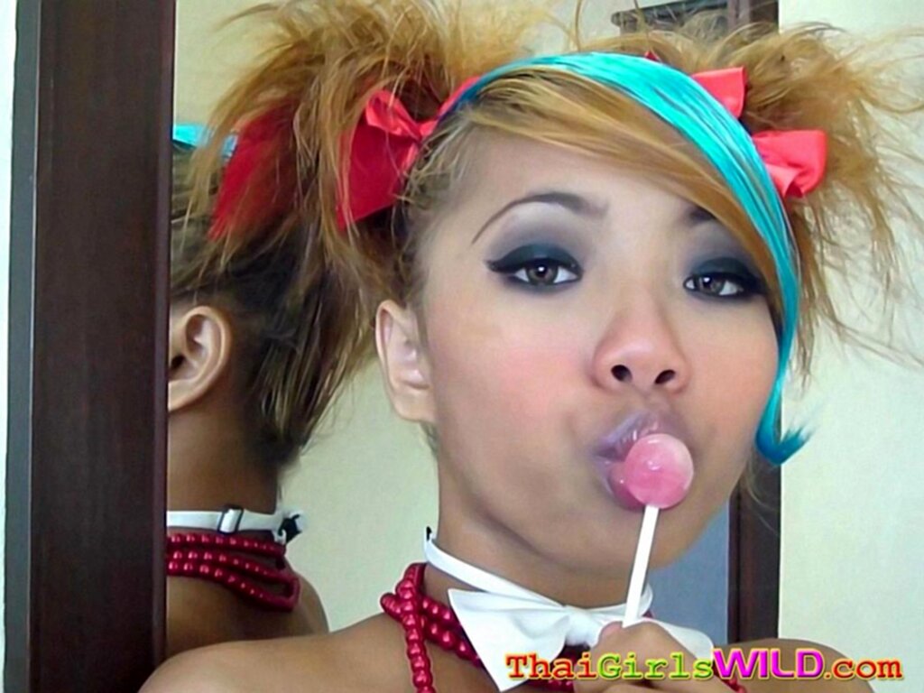 Lips pursed against lollipop
