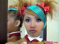 Hair up in ribbons lips pursed wearing white bow tie